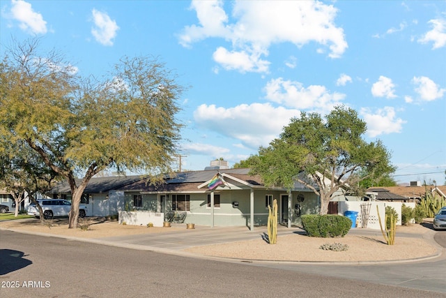 ranch-style home with solar panels