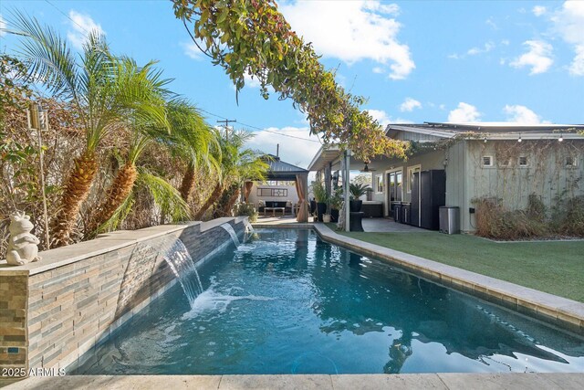 view of swimming pool featuring pool water feature and a lawn