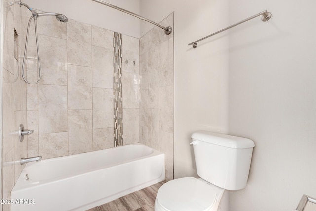 bathroom featuring hardwood / wood-style floors, toilet, and tiled shower / bath