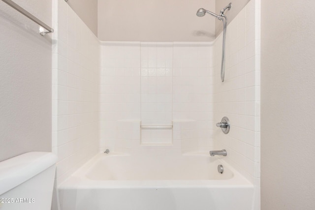 bathroom featuring bathing tub / shower combination and toilet