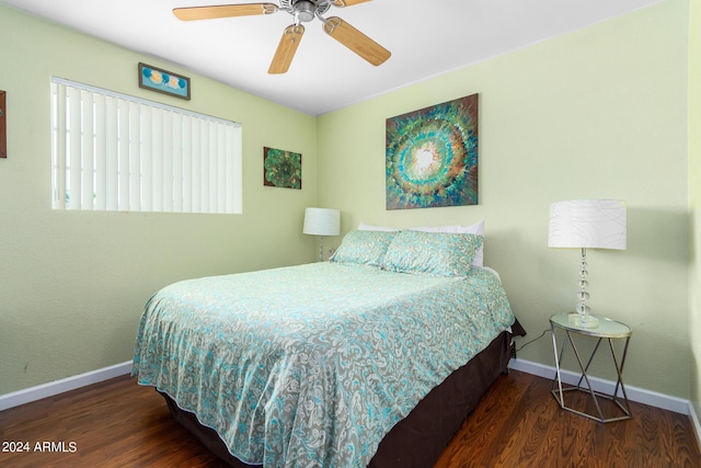 bedroom featuring a ceiling fan, baseboards, and dark wood-type flooring