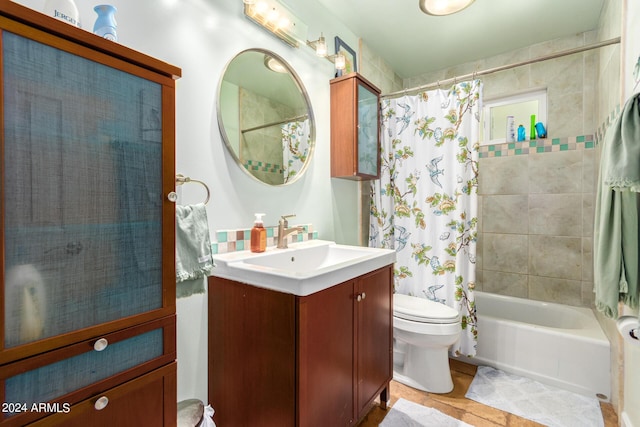 bathroom featuring toilet, shower / bathtub combination with curtain, and vanity