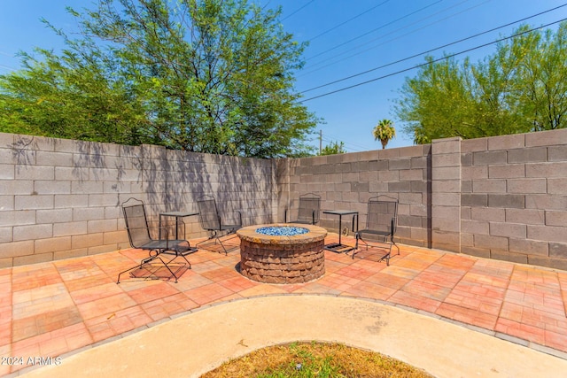 view of patio / terrace featuring a fenced backyard and a fire pit