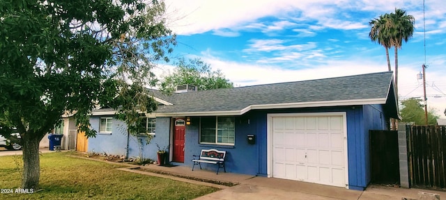 ranch-style house with driveway, a shingled roof, an attached garage, a front lawn, and stucco siding