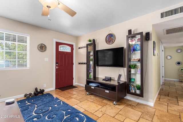 foyer featuring stone tile floors, visible vents, and baseboards