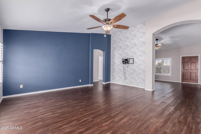 8500 W Saint John Rd, Peoria, AZ 85382 - unfurnished living room with ceiling fan, arched walkways, wood finished floors, and baseboards
