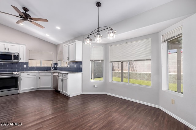 8500 W Saint John Rd, Peoria, AZ 85382 - kitchen featuring stainless steel appliances, tasteful backsplash, white cabinetry, healthy amount of natural light, and vaulted ceiling