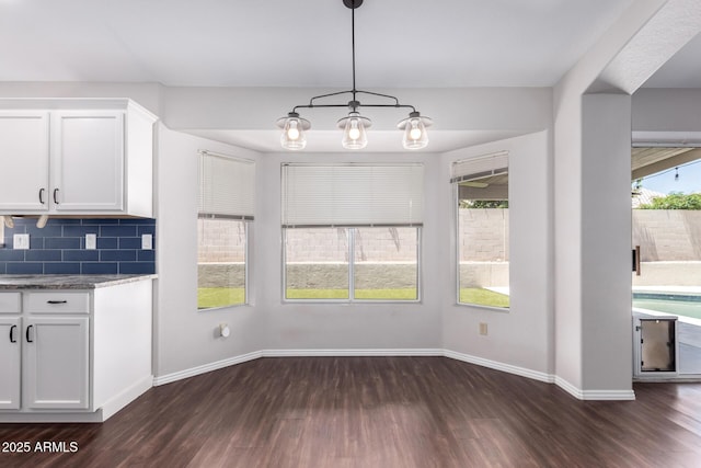 8500 W Saint John Rd, Peoria, AZ 85382 - unfurnished dining area with dark wood finished floors and baseboards