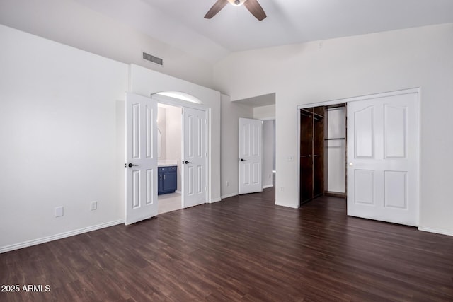 8500 W Saint John Rd, Peoria, AZ 85382 - unfurnished bedroom featuring dark wood-type flooring, vaulted ceiling, baseboards, ensuite bathroom, and a ceiling fan