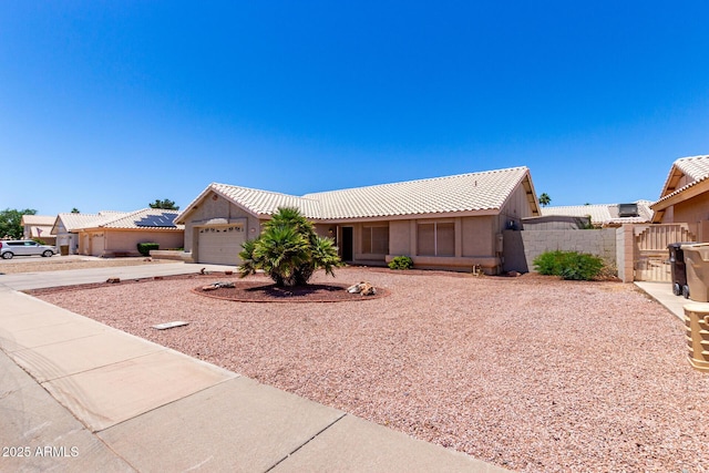 8500 W Saint John Rd, Peoria, AZ 85382 - single story home featuring a gate, concrete driveway, a tiled roof, an attached garage, and stucco siding