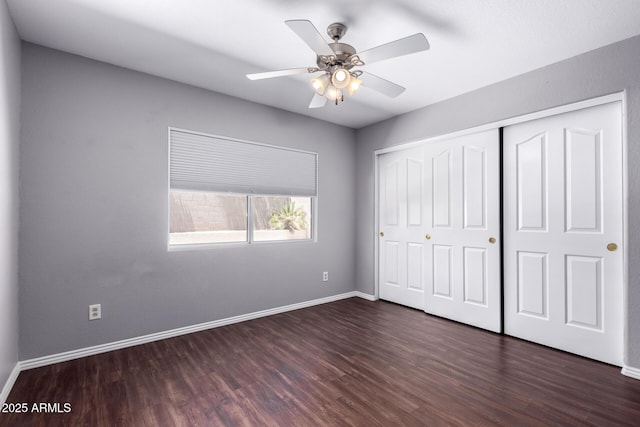 8500 W Saint John Rd, Peoria, AZ 85382 - unfurnished bedroom with dark wood finished floors, baseboards, and a closet