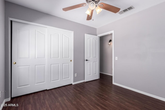 8500 W Saint John Rd, Peoria, AZ 85382 - unfurnished bedroom with baseboards, wood finished floors, a closet, and a ceiling fan