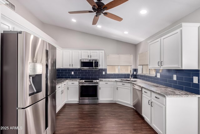 8500 W Saint John Rd, Peoria, AZ 85382 - kitchen featuring appliances with stainless steel finishes, a sink, lofted ceiling, tasteful backsplash, and white cabinets