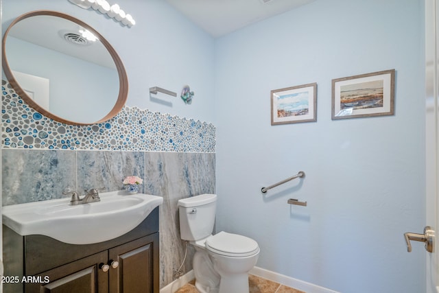 bathroom with tile patterned floors, vanity, and toilet