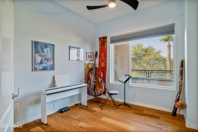 misc room with ceiling fan and light wood-type flooring