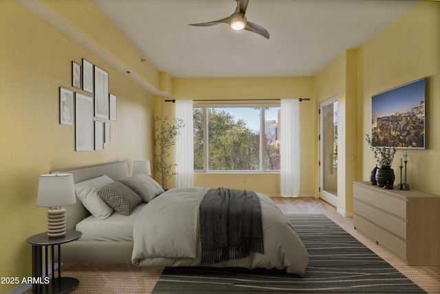 bedroom featuring access to outside, light colored carpet, and ceiling fan