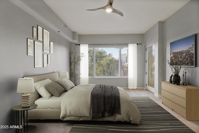 bedroom featuring ceiling fan and access to exterior