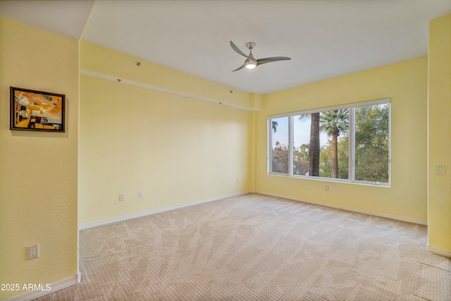 unfurnished room featuring light carpet and ceiling fan