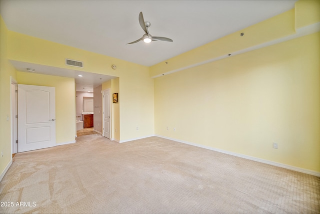 spare room featuring ceiling fan and light carpet