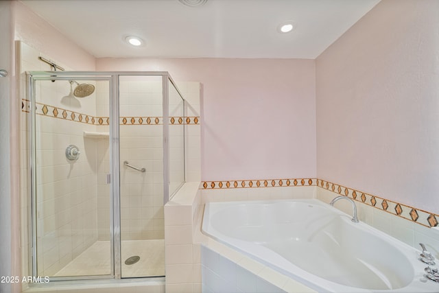 bathroom featuring shower with separate bathtub