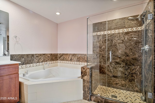 bathroom featuring independent shower and bath and vanity