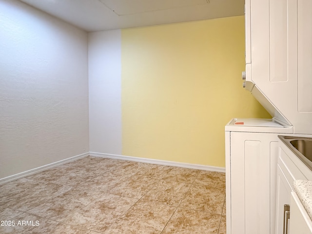 clothes washing area with stacked washer / dryer