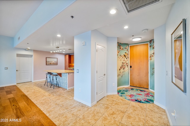 entryway with light tile patterned flooring