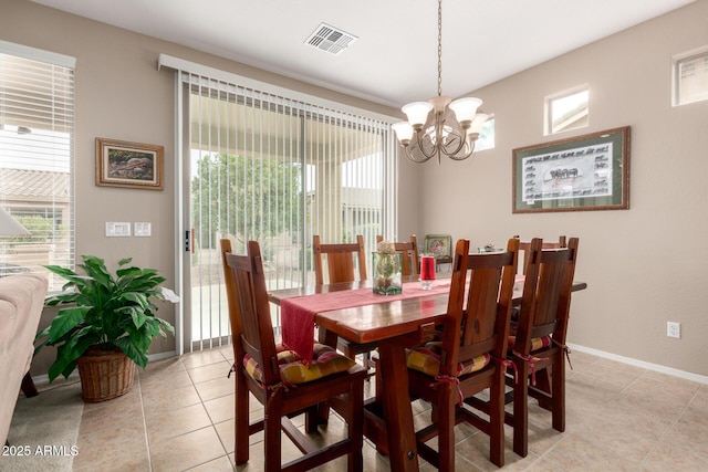 dining space featuring light tile patterned flooring, visible vents, baseboards, and an inviting chandelier