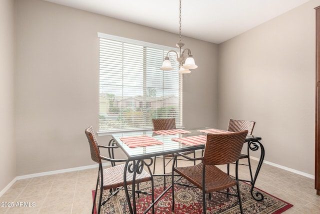 dining space with light tile patterned flooring, a notable chandelier, and baseboards