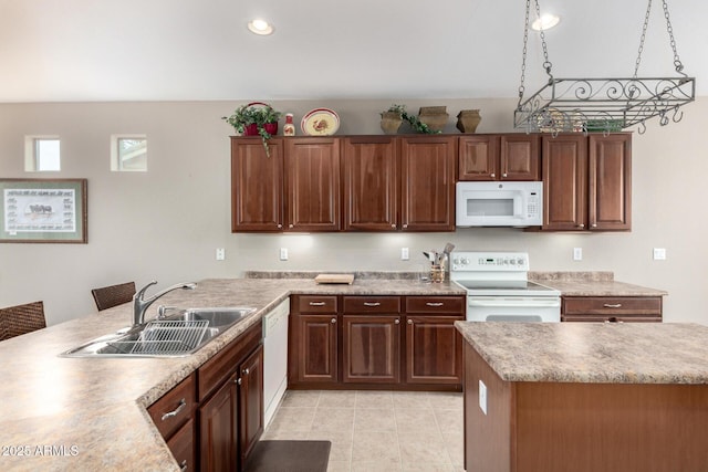 kitchen featuring a sink, recessed lighting, white appliances, a peninsula, and light countertops