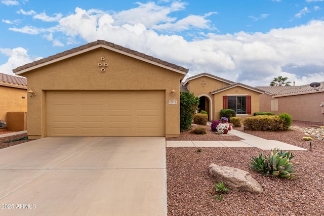 mediterranean / spanish house with stucco siding, an attached garage, driveway, and a tiled roof