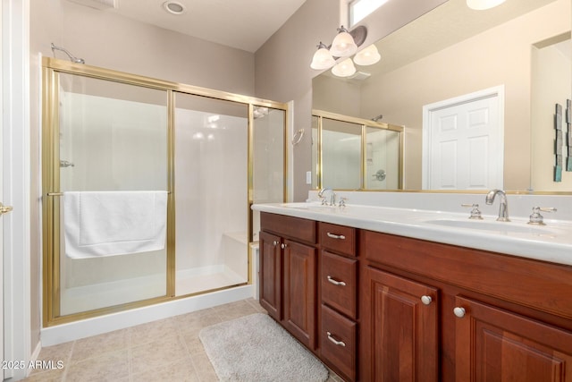 bathroom with tile patterned flooring, a stall shower, double vanity, and a sink