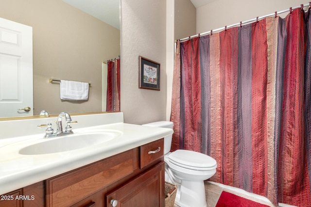 full bath featuring toilet, vanity, and tile patterned flooring