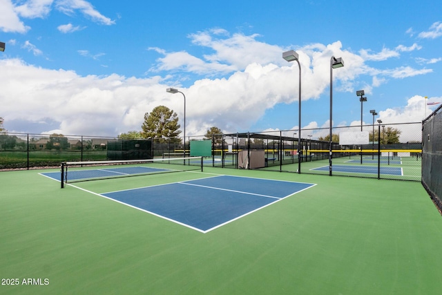 view of tennis court with fence