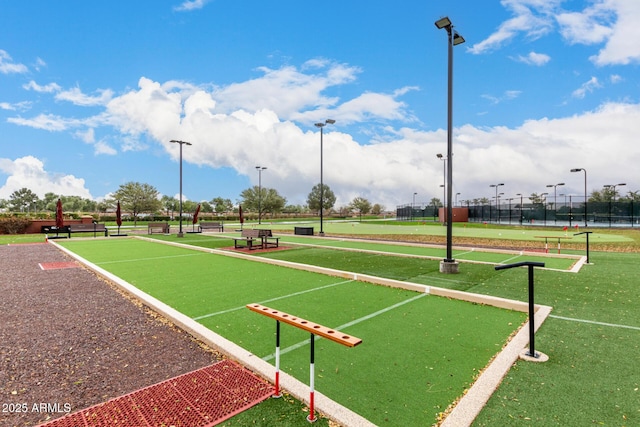 view of property's community featuring fence