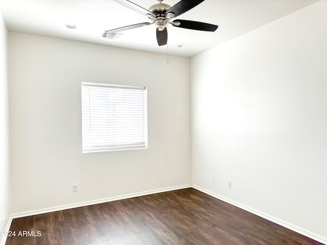 empty room with ceiling fan and dark wood-type flooring