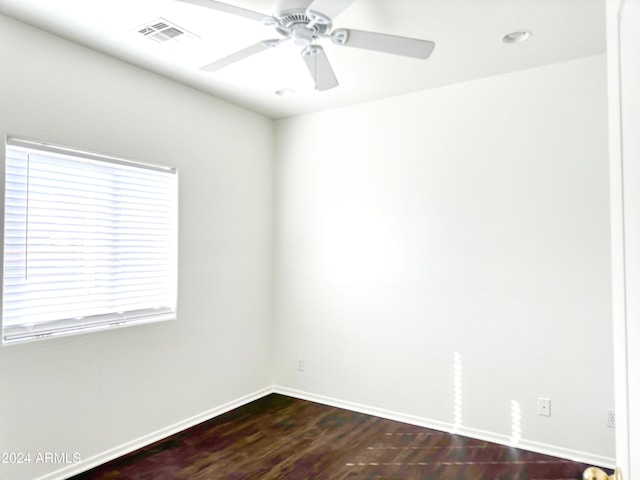 spare room with hardwood / wood-style floors and ceiling fan