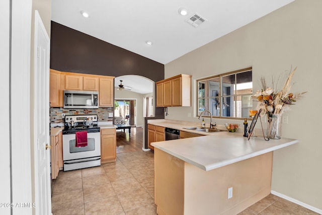 2738 E Silversmith Trl, San Tan Valley, AZ 85143 - kitchen with stainless steel appliances, a sink, light brown cabinets, vaulted ceiling, and a ceiling fan