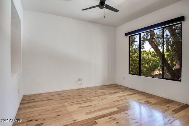 empty room with ceiling fan and light wood-type flooring