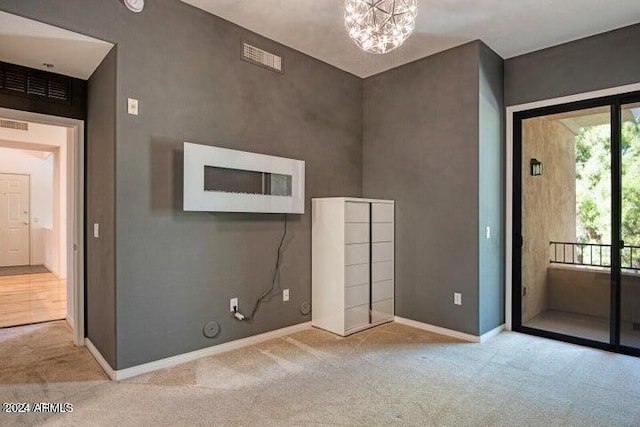 interior space featuring light carpet and an inviting chandelier