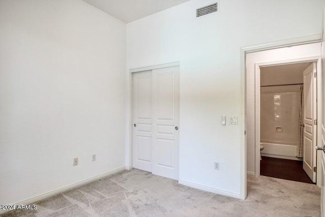 unfurnished bedroom featuring light colored carpet