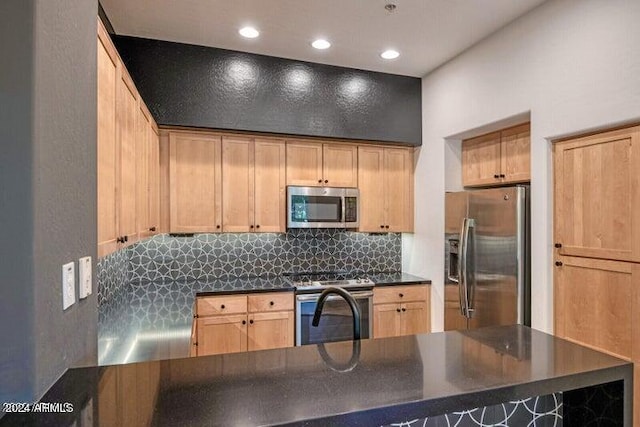 kitchen with stainless steel appliances, light brown cabinetry, and tasteful backsplash