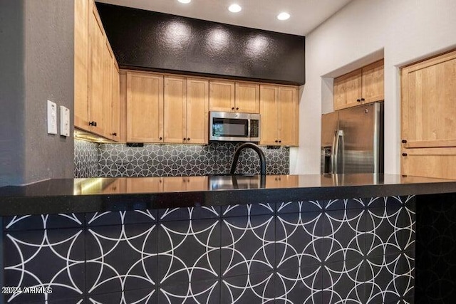 kitchen featuring appliances with stainless steel finishes and backsplash