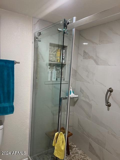 bathroom with toilet and walk in shower