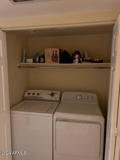 clothes washing area featuring independent washer and dryer