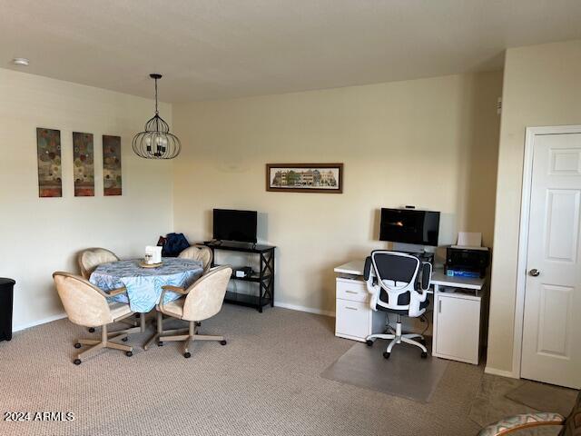 office featuring a chandelier and carpet flooring