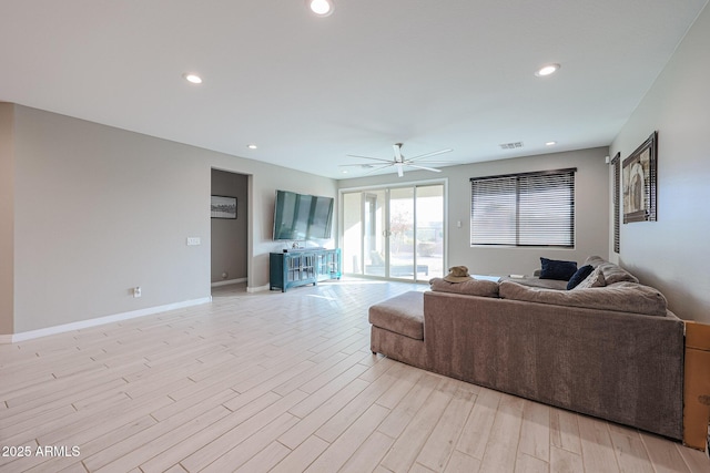 living room featuring ceiling fan and light wood-type flooring