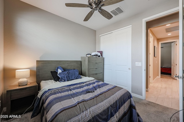 carpeted bedroom featuring a closet and ceiling fan