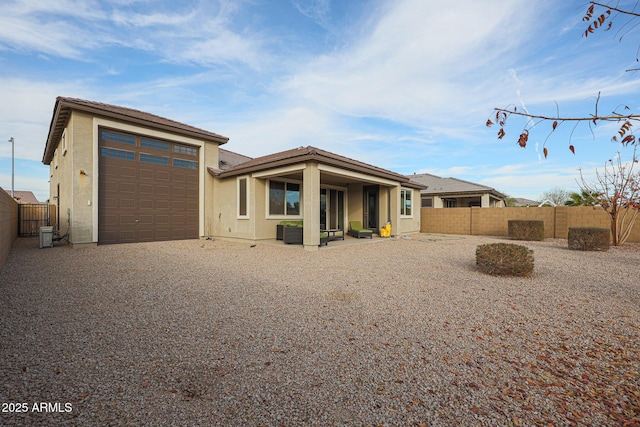 back of property featuring a garage