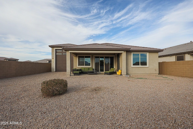 back of house with an outdoor living space and a patio